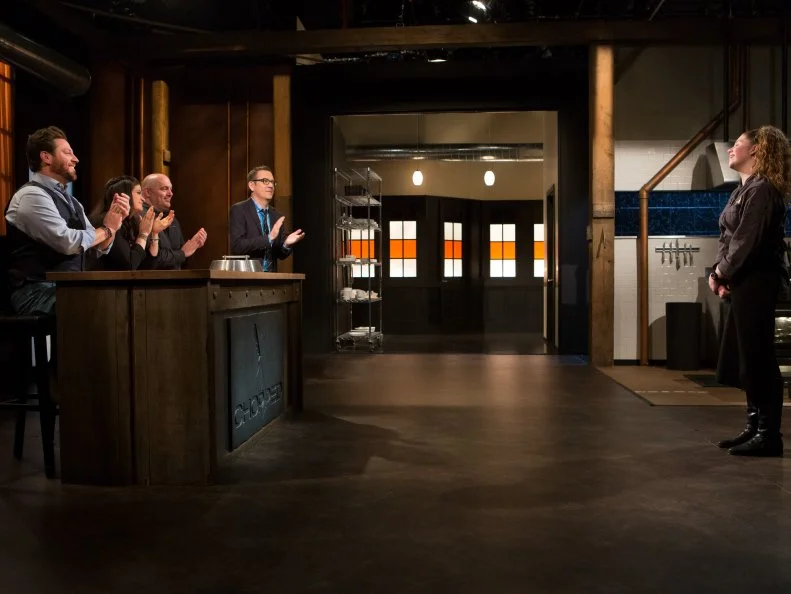 14 year old Alexina Chasin stands before Chopped host Ted Allen and judges: Scott Conant, Alex Guarnaschelli and Chris Santos moments after finding she is a Teen Chopped Champion and has secured a spot in the $25,000 finale for Chopped Teen Week $25,000 tournament, as seen on Food Network's Chopped, Season 25.