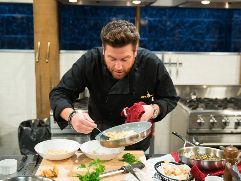 Scott Conant during a carnival theme webisode cooking with hot beef sundae,deep fried ravioli, asparagus, and deep fried canned ham, as seen on Food Networkâ  s Chopped, season 24.