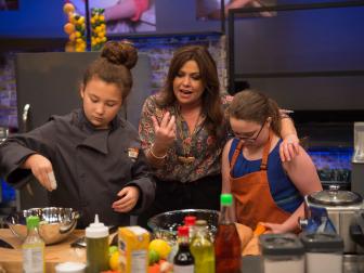 Host Rachael Ray helps finalist Scarlett Smorynski and her sous-chef, contestant Sabrina Richard as she races to finish her dish during the "Put It All Together" Finale Cook-Off challenge as seen on Food Networkâ  s Rachael Rayâ  s Kids CookÂ­â  Off, Season 1.