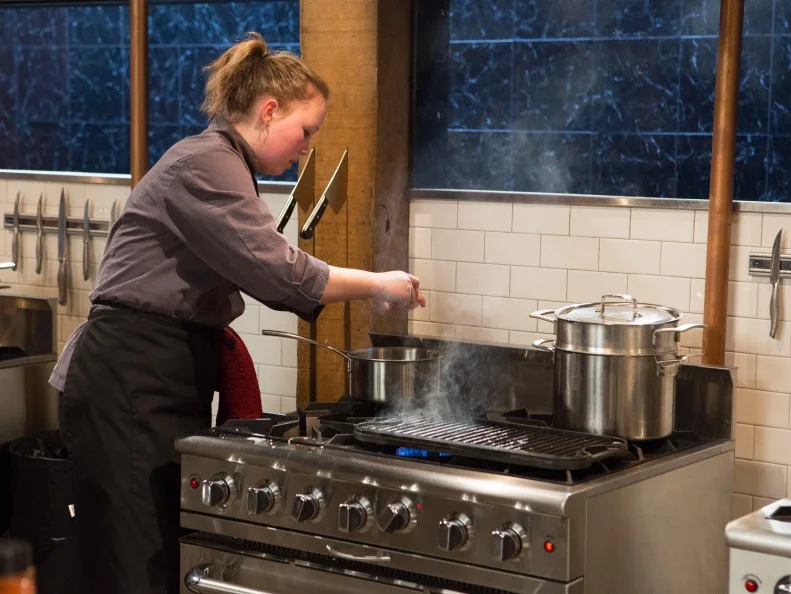 13 year old Olivia Neumark as she works on her entree that must include: veal chops, heirloom tomatoes, glazed donuts and swiss chard for Chopped Teen Week $25,000 tournament, as seen on Food Network's Chopped, Season 25.