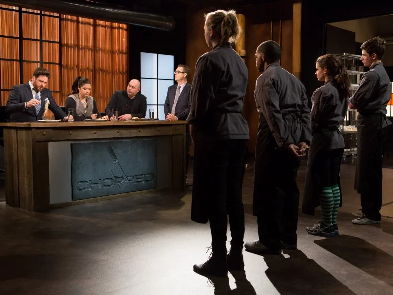 Teens: 15 year old Danny Ganzman, 15 year old Veronica Seguin, 16 year old Justin Ballenger and 13 year old Olivia Neumark stand before Chopped host Ted Allen and judges: Scott Conant, Alex Guarnaschelli and Chris Santos to defend their appetizers that must have included: spicy Italian sausage, white asparagus, habanero peppers and soup dumplings for Chopped Teen Week $25,000 tournament, as seen on Food Network's Chopped, Season 25.