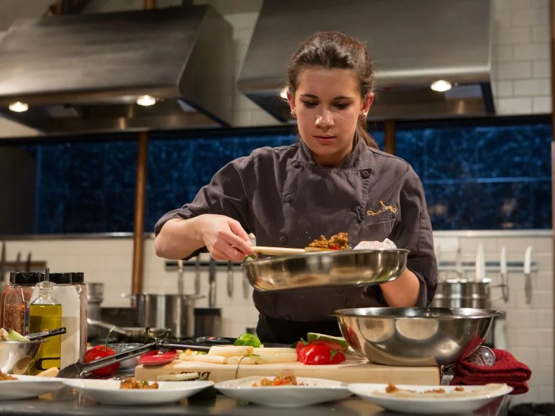 15 year old Veronica Seguin works on her appetizer that must include: spicy Italian sausage, white asparagus, habanero peppers and soup dumplings for Chopped Teen Week $25,000 tournament, as seen on Food Network's Chopped, Season 25.