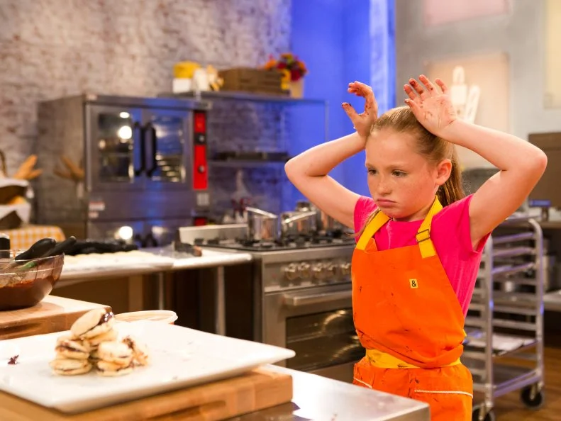 Time runs out as contestant Peggy Fischer fails to stack her Almond Macarons with dark chocolate ganache to the 5 inch height requirement during the "Stackarons" challenge, as seen on Food Network's Kids Baking Championship, Season 2.