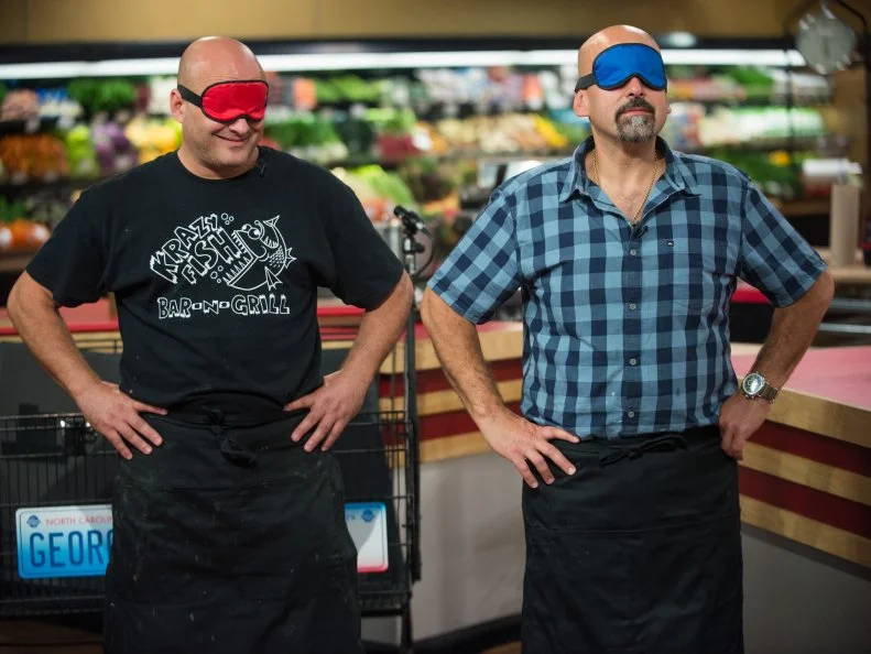 Contestants George Prisco and Jay Hajj are blindfolded for the "Out of Sight" game, as seen on Food Network's Guy's Grocery Games, Season 8.