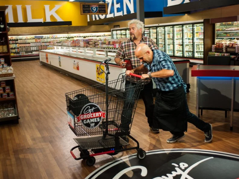 Host Guy Fieri sends contestant Jay Hajj to shop one last time, as seen on Food Network's Guy's Grocery Games, Season 8.