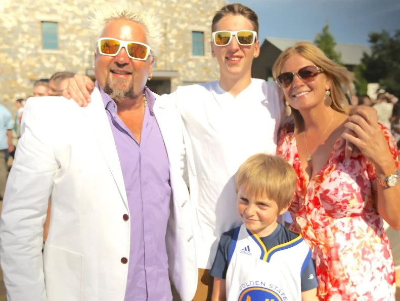 A family portrait shot of the Fieri family at Hunter Fieri's graduation as seen in Food Network's Guy's European Vacation episode 1.