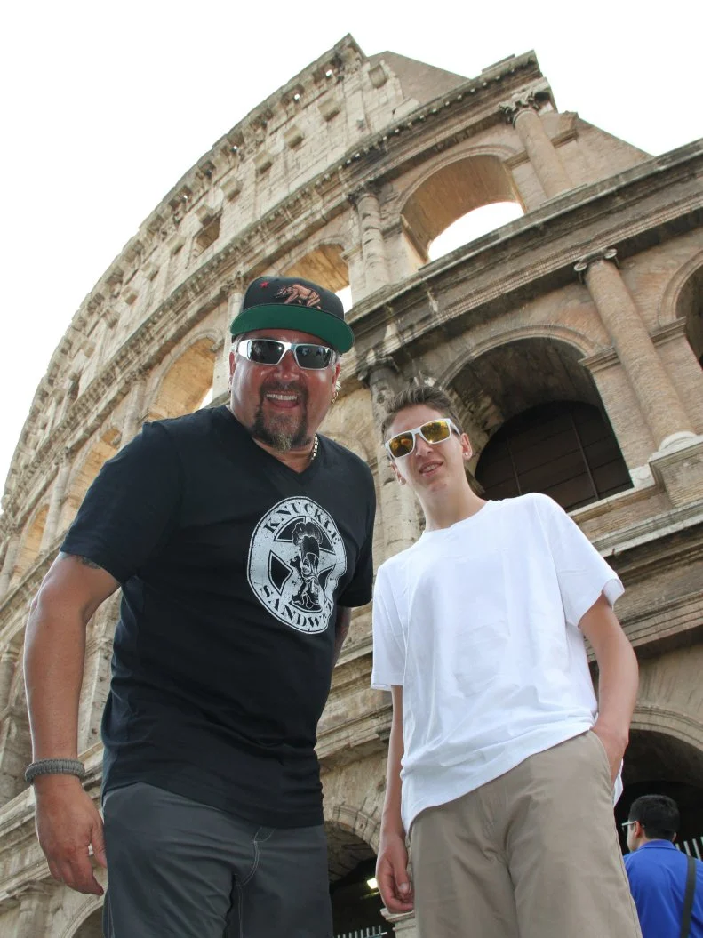 Portrait shot of Guy Fieri and Hunter Fieri in front of the Coliseum in Rome, Italy as seen on Food Network's Guy's European Vacation episode 2.