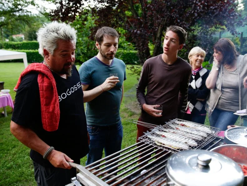 Guy and Hunter Fieri in Sesto Calende, Italy at Guy's cousins' house grilling fish as seen on Food Network's Guy's European Vacation episode 2.