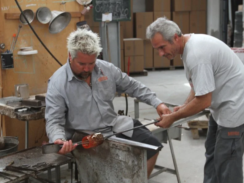 Guy Fieri learning to glass blow in Venice, Italy as seen on Food Network's Guy's European Vacation episode 3.