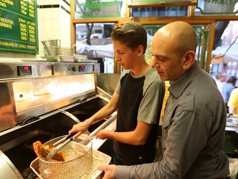 Hunter is learining how to make fish and chips with chef/owner Amet of Rock and Sole in London, England as seen on Food Network's Guy's European Vacation episode 4.