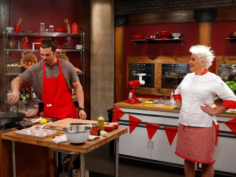 Host Anne Burrell checks in on red team recruit Nick Slater as he cooks during the skill drill challenge as seen on Food Network's Worst Cooks in America, Season 8.