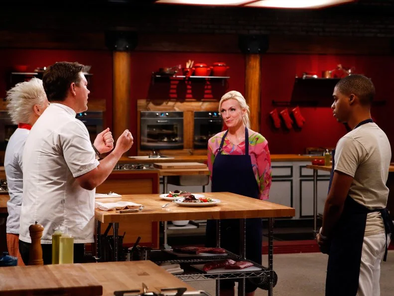 Co-Hosts Tyler Florence and Anne Burrell taste the blue team's dish following the skill drill challenge as seen on Food Network's Worst Cooks in America, Season 8.