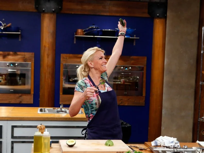 Blue team recruit Ginny Meerman cooks Tyler Florence's Pan Seared Chicken Thighs with Mexican Rice Paella Style with Avocado and Green Olives dish during the elimination challenge as seen on Food Network's Worst Cooks in America, Season 8.