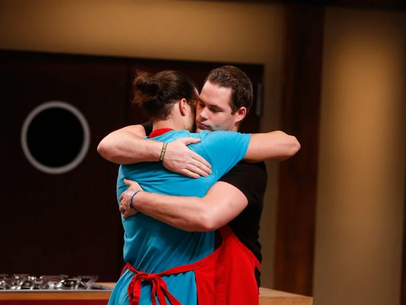 Red team recruits Nick Slater, left, and Taylor Hoopers react as Slater is announced as the red team winner during elimination as seen on Food Network's Worst Cooks in America, Season 8.