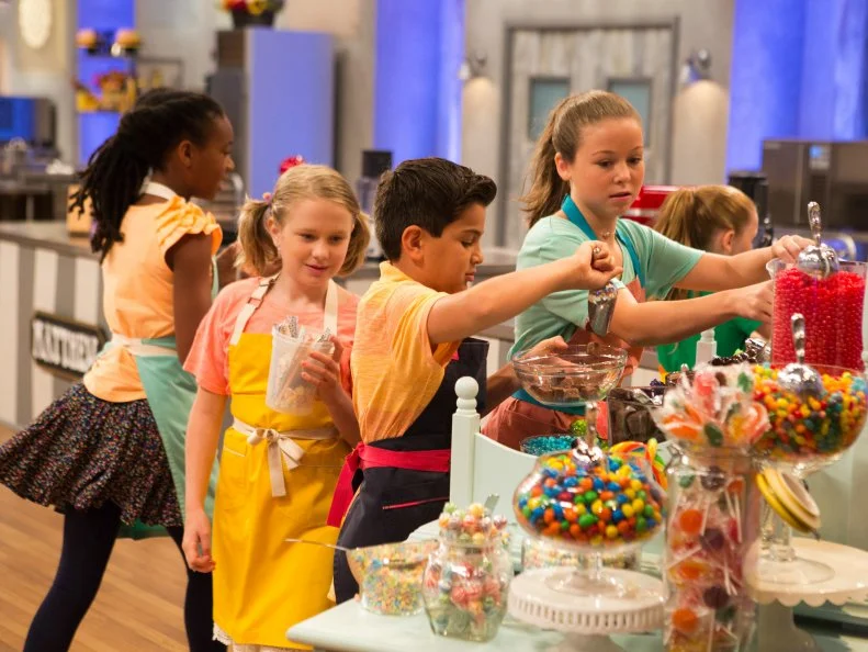 Contestants select their candy for the "Candymonium" challenge, as seen on Food Network's Kids Baking Championship, Season 2.