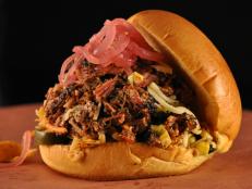 <p>Michael Symon and Eddie Jackson head to LeAnn Mueller&rsquo;s laid-back joint to try El Loco. Brisket and pork butt are rubbed with mustard and pickle juice, hit with salt and pepper, then smoked and piled onto a bun. Chipotle slaw, pickled red onions, and black bean and corn salad round out the sandwich.</p>