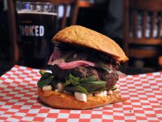 A trove of family recipes has inspired the meaty creations here, like the Big Fat Greek Burger that Michael Symon says speaks to his &ldquo;very soul.&rdquo; A beef patty comes loaded with Greek flavors, thanks to additions like a bright olive tapenade, a creamy red pepper hummus and crunchy pickled cucumbers.