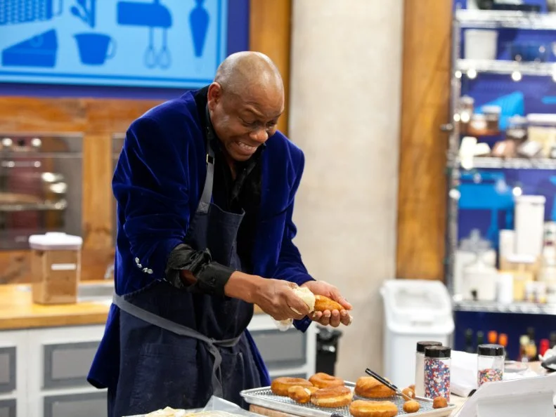 Contestant Carey Westbrook struggles to add the filling to his County Fair Donuts, as seen on Food Network's Worst Bakers In America, Season 1.