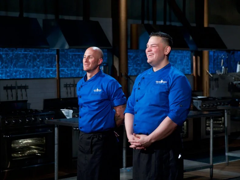 Chefs Jay Abrams (L) and Demetrio Zavala during the judging of the dessert round, as seen on Food Network's Chopped, Season 31.