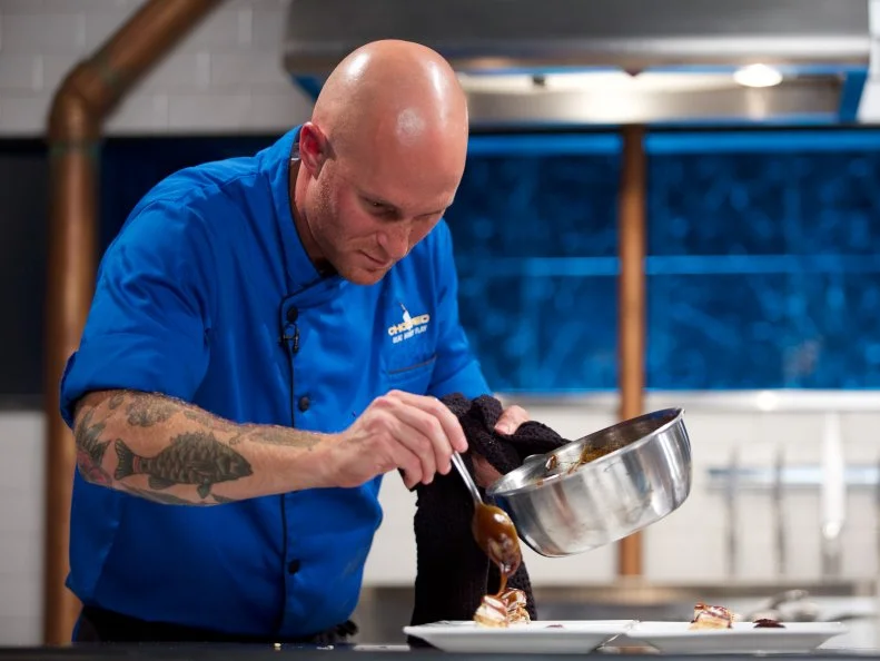 Chef Jay Abrams cooks Marcona almond pear and American cheese stuffed phyllo with a mayhem caramel sauce and a wine and raspberry compote during the dessert round, as seen on Food Network's Chopped, Season 31.