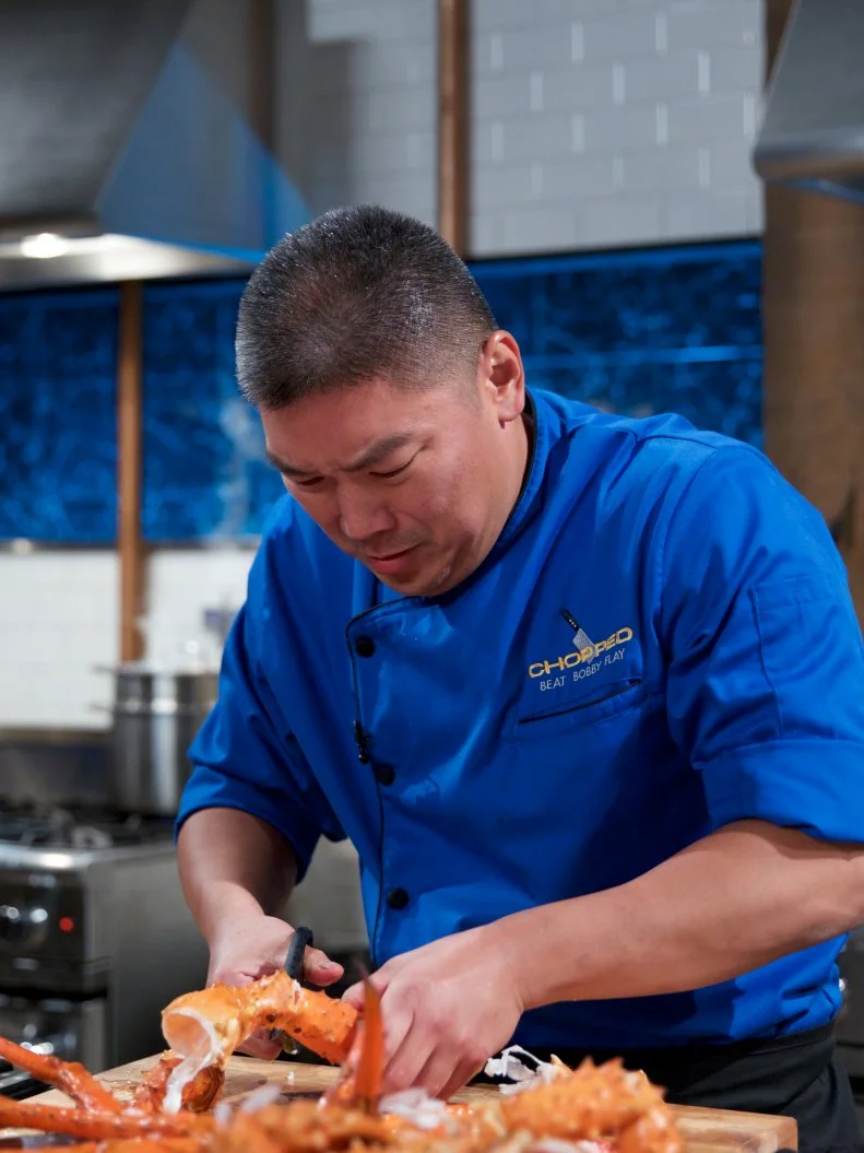 Chef Seis Kamimura cooks Alaskan king crab with flavors of bouillabaisse and snap pea during the entrŽe round, as seen on Food Network's Chopped, Season 31.