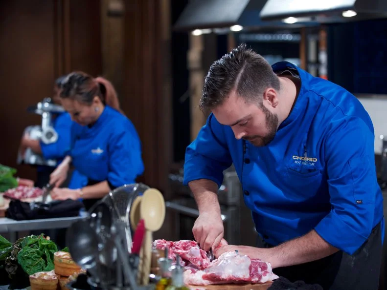 Chefs Kathy Fang (L) and Matt Romine cook during the entrŽe round, as seen on Food Network's Chopped, Season 31.
