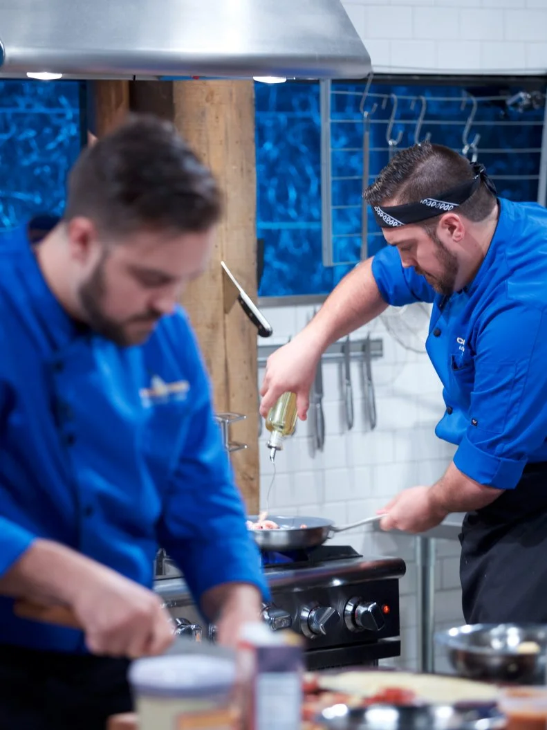 Chefs Matt Romine (L) and twin brother Mike Romine cooks during the appetizer round, as seen on Food Network's Chopped, Season 31.