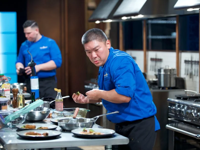 Chefs Demetrio Zavala (L) and Seis Kamimura cook during the entrŽe round, as seen on Food Network's Chopped, Season 31.