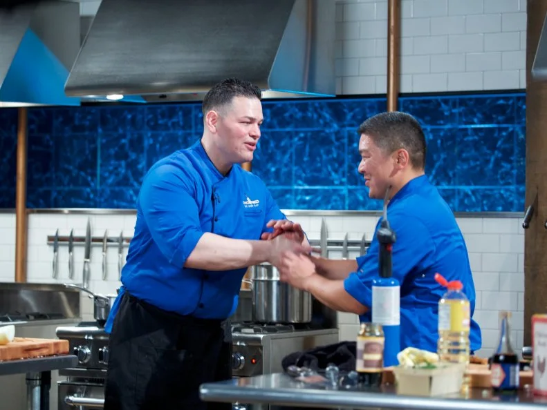 Chefs Demetrio Zavala (L) and Seis Kamimura shake hands after cooking during the entrŽe round, as seen on Food Network's Chopped, Season 31.