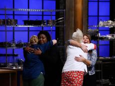 Mentor Anne Burrell and recruit Nicole Sullivan of the red team and mentor Rachael Ray and recruit Loni Love of the blue team react after Love was named the winner during the final elimination, as seen on Food Network's Worst Cooks in America, Season 9.