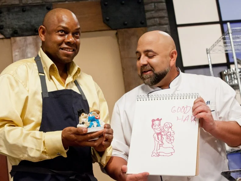 Host Duff Goldman and contestant Carey Westbrook have a laugh after they look at Kelly's design drawing and his final sculpted wedding cake topper.  As seen on Food Network's Worst Bakers In America, Season 1.