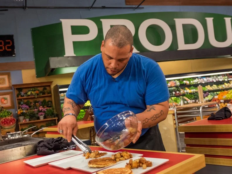 Contestant Kevin Champion slices potatoes, as seen on Food Network's Guy's Grocery Games, Season 11.