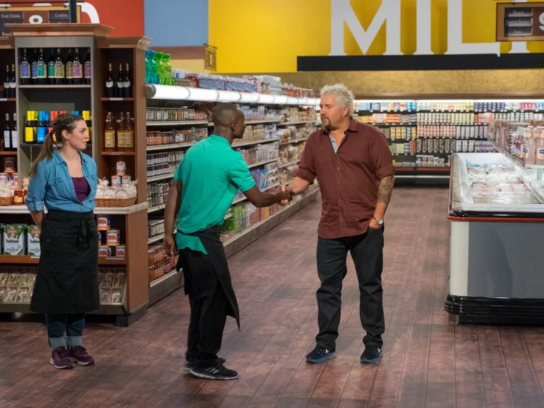 Host Guy Fieri shakes hands with contestant Andy Hyde, as seen on Food Network's Guy's Grocery Games, Season 11.
