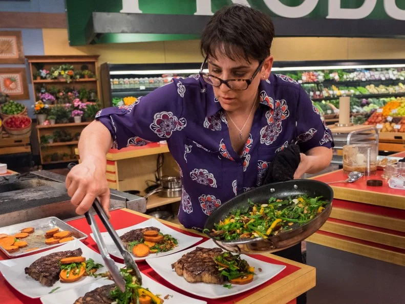 Contestant Nelle Bauer plates her dish for the judges, as seen on Food Network's Guy's Grocery Games, Season 11.
