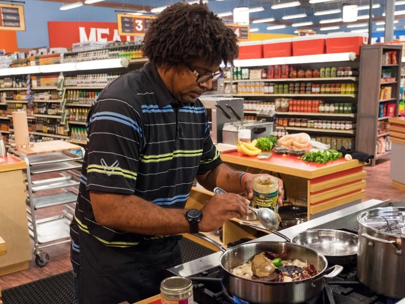 Contestant Stephen Jones prepares his dish for the judges, as seen on Food Network's Guy's Grocery Games, Season 11.