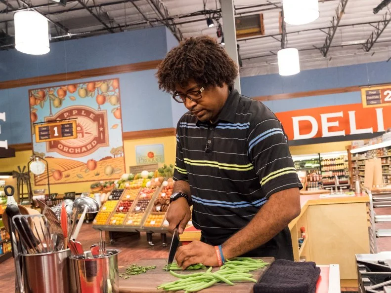 Contestant Stephen Jones prepares his dish, as seen on Food Network's Guy's Grocery Games, Season 11.