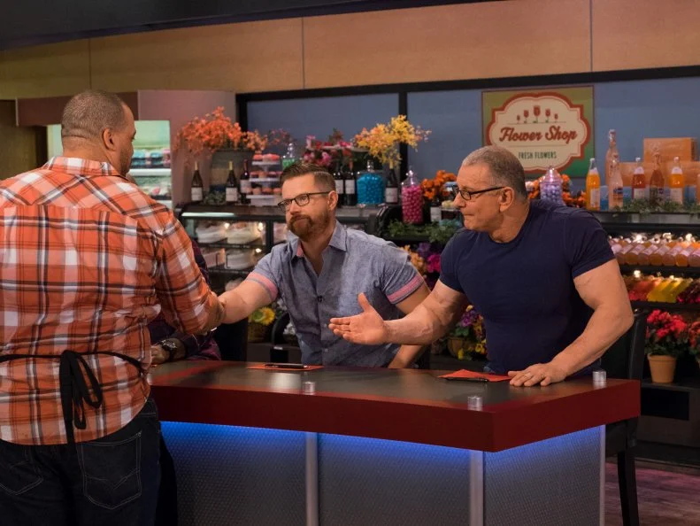 Contestant Kevin Champion shakes hands with judges G. Garvin, Richard Blais, and Robert Irvine, as seen on Food Network's Guy's Grocery Games, Season 11.