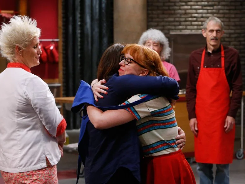 Buffy Mykkanen of the blue team hugs mentor Rachael Ray after being eliminated, as seen on Food Network's Worst Cooks in America, Season 10.