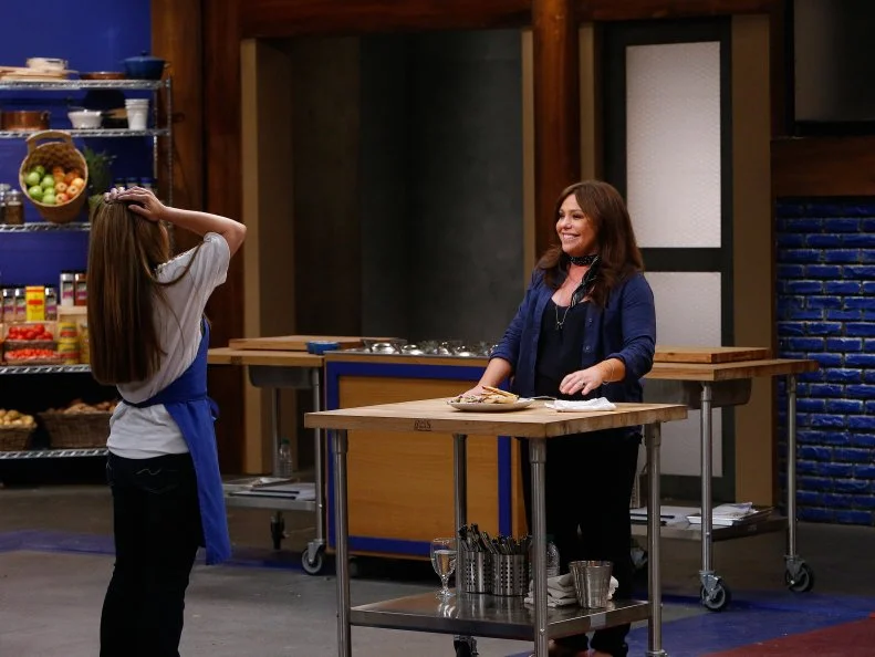 Mentor Rachael Ray tastes Maria Marcello's dish during the blue team's skill drill tasting, as seen on Food Network's Worst Cooks in America, Season 10.