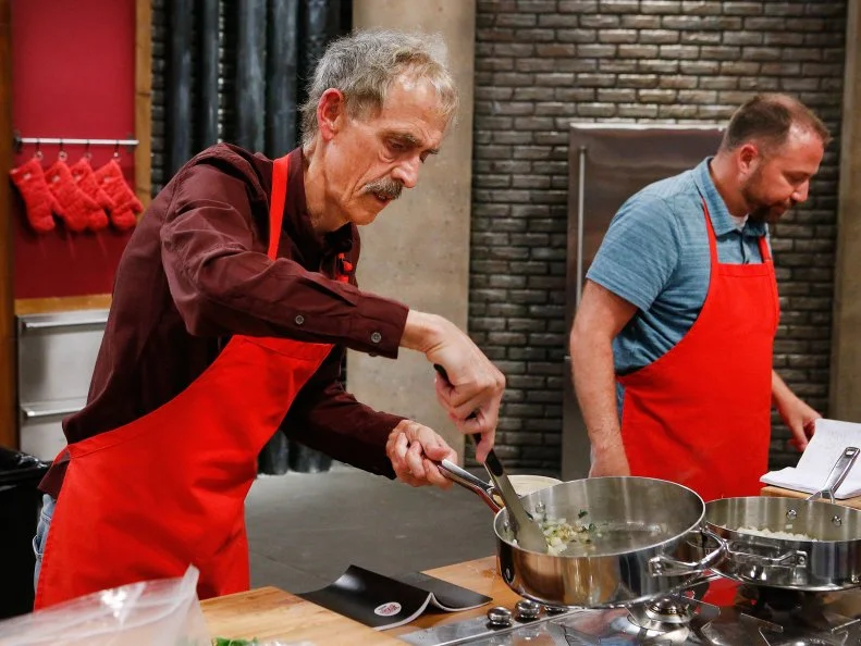 Stephen Hawkins and Jeff West of the red team cook during the main dish challenge, as seen on Food Network's Worst Cooks in America, Season 10.