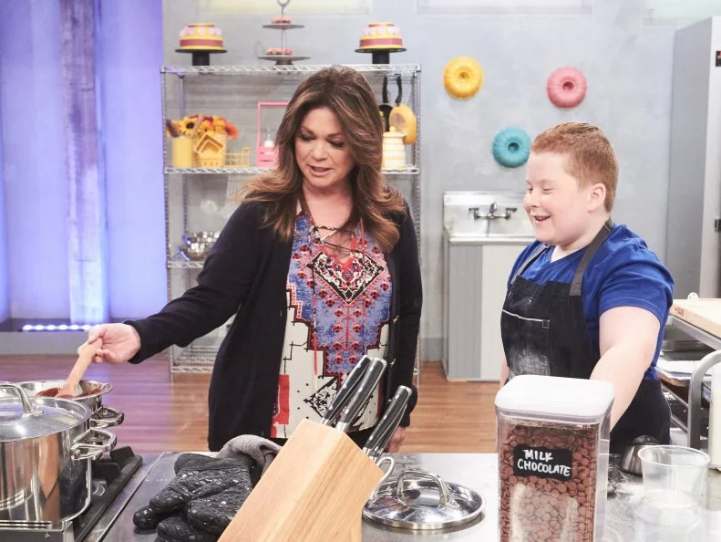 Host Valerie Bertinelli watches Contestant Jason Intravartolo preparing his Main Heat dish, Burrito with Crepe "Tortilla" with Chocolate "Refried Beans", Pound Cake "Chicken" and Buttercream "Sour Cream", as seen on Food Network's Kids Baking Championship, Season 3.