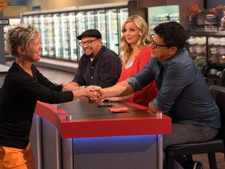 Contestant Brigitte Blodsoe says goodbye to judges Carl Ruiz, Damaris Phillips and Troy Johnson, as seen on Food Network's Guy's Grocery Games, Season 12.