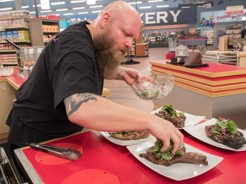 Contestant Louie Finnan puts the finishing touches on his dish, as seen on Food Network's Guy's Grocery Games, Season 12.