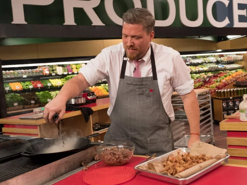 Contestant Peter Campbell prepares his dish, as seen on Food Network's Guy's Grocery Games, Season 12.