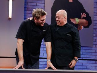 Mentors Curtis Stone, left, and Andrew Zimmern talk after the first round as seen on Food Network's All-Star Academy, Season 2.