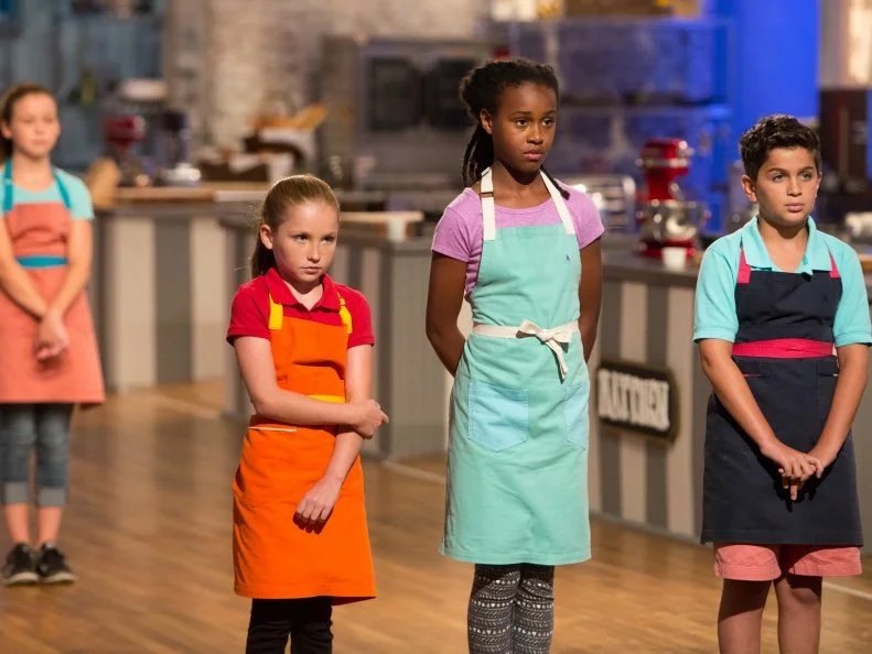 Bottom three contestants Peggy Fischer, Yashimabet Sellassie, and Matthew Merril wait nervously for elimination after the "Dessert Imposter 2.0" challenge, as seen on Food Network's Kids Baking Championship, Season 2.