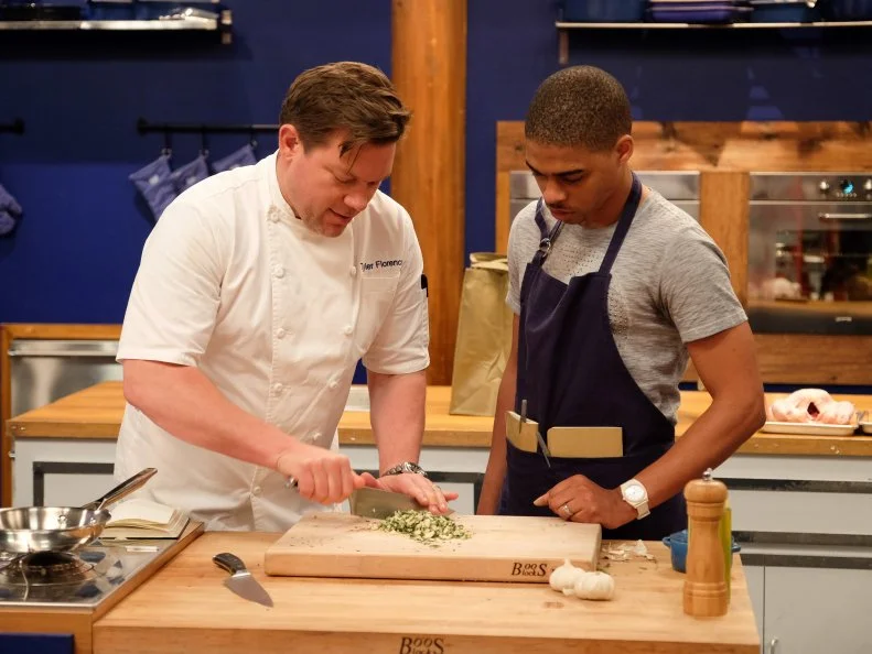 Host Tyler Florence works with finalist, Lawrence Crawford on a menu of béarnaise deviled eggs, osetra caviar, crispy shallots and tarragon; fried chicken, oven roasted ratatouille, and summer corn purée; peach upside down cake with basil ice cream and pistachio cookie crumble, as seen on Food Network’s Worst Cooks In America, Season 8.