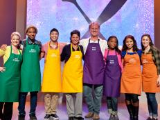 All eight cook contestants pose on stage before competing with each other on All Star Academy, as seen on the Food Network's All Star Academy, Season 2. From left to right: Natasha Clement, Jermaine Wright, Dain Lee, Lynn Duffy,Stanley Abbot, Lisa Washington, Zoe Arevalo, and Anna Cooper.