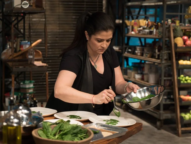 Contestant Alex Guarneschelli races to finish her Round 1 spinach dish, as seen on Food Network's Beat Bobby Flay, Season 8.