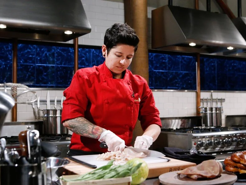 Chef Stacey Givens cooks with pig ears, papaya, green Romano beans and soft pretzels during the appetizer round, as as seen on Food Network's Chopped, Season 28.